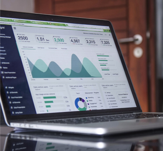 laptop showing data analysis on screen